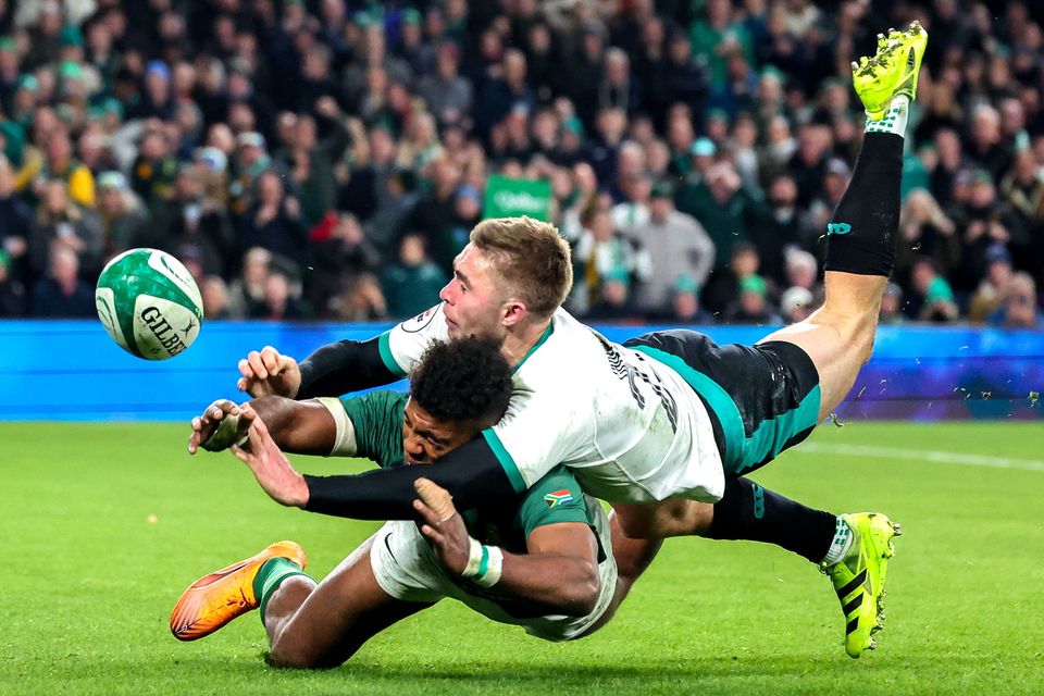 Jack Crowley gets back in the nick of time to prevent Springboks winger Canan Moodie from scoring a try. Photo: John Dickson/Sportsfile
